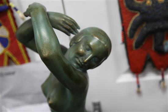 A French Art Deco painted terracotta model of a female nude dancer, 28in.